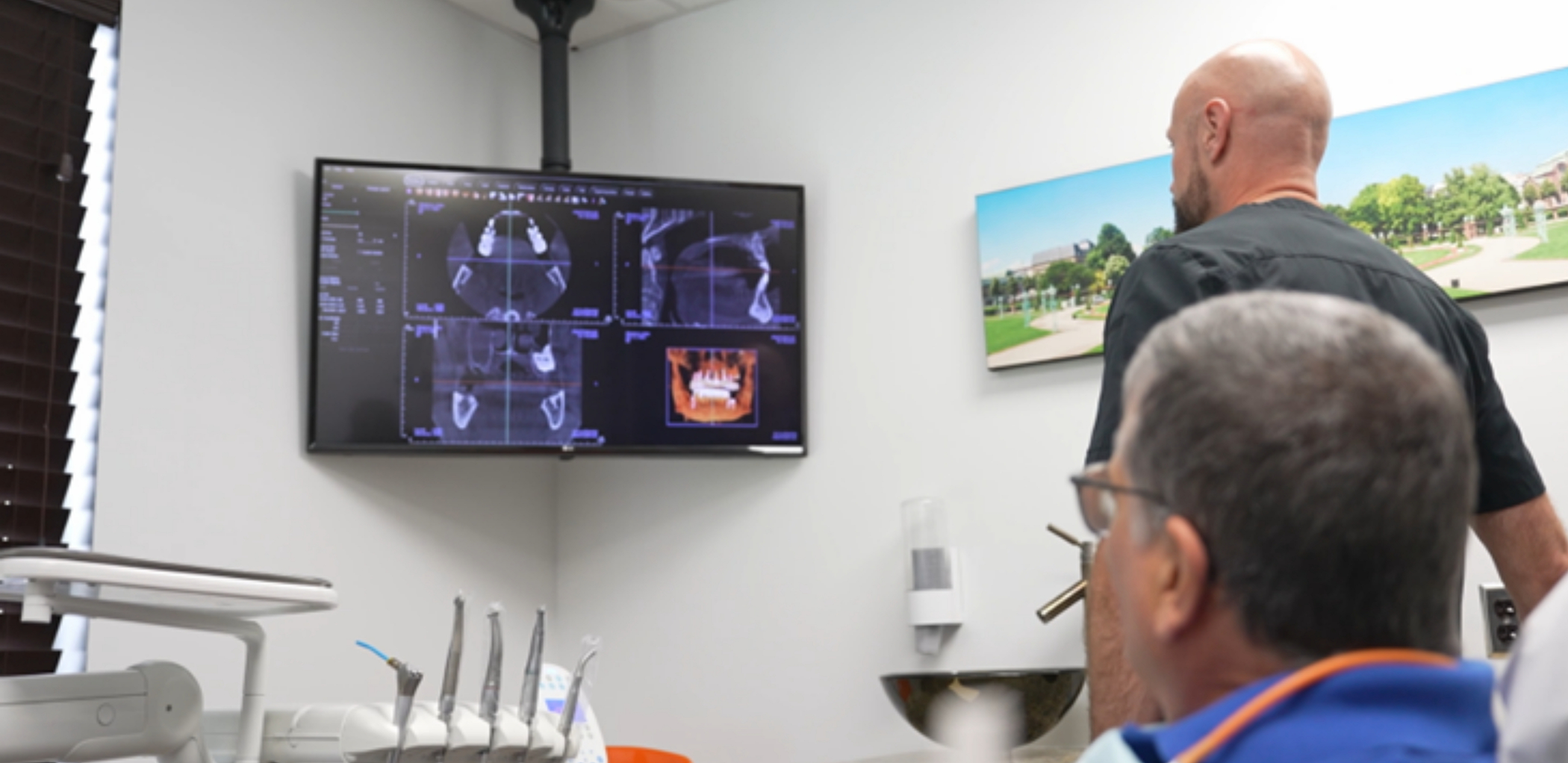 Dentist showing a patient x-rays of their teeth