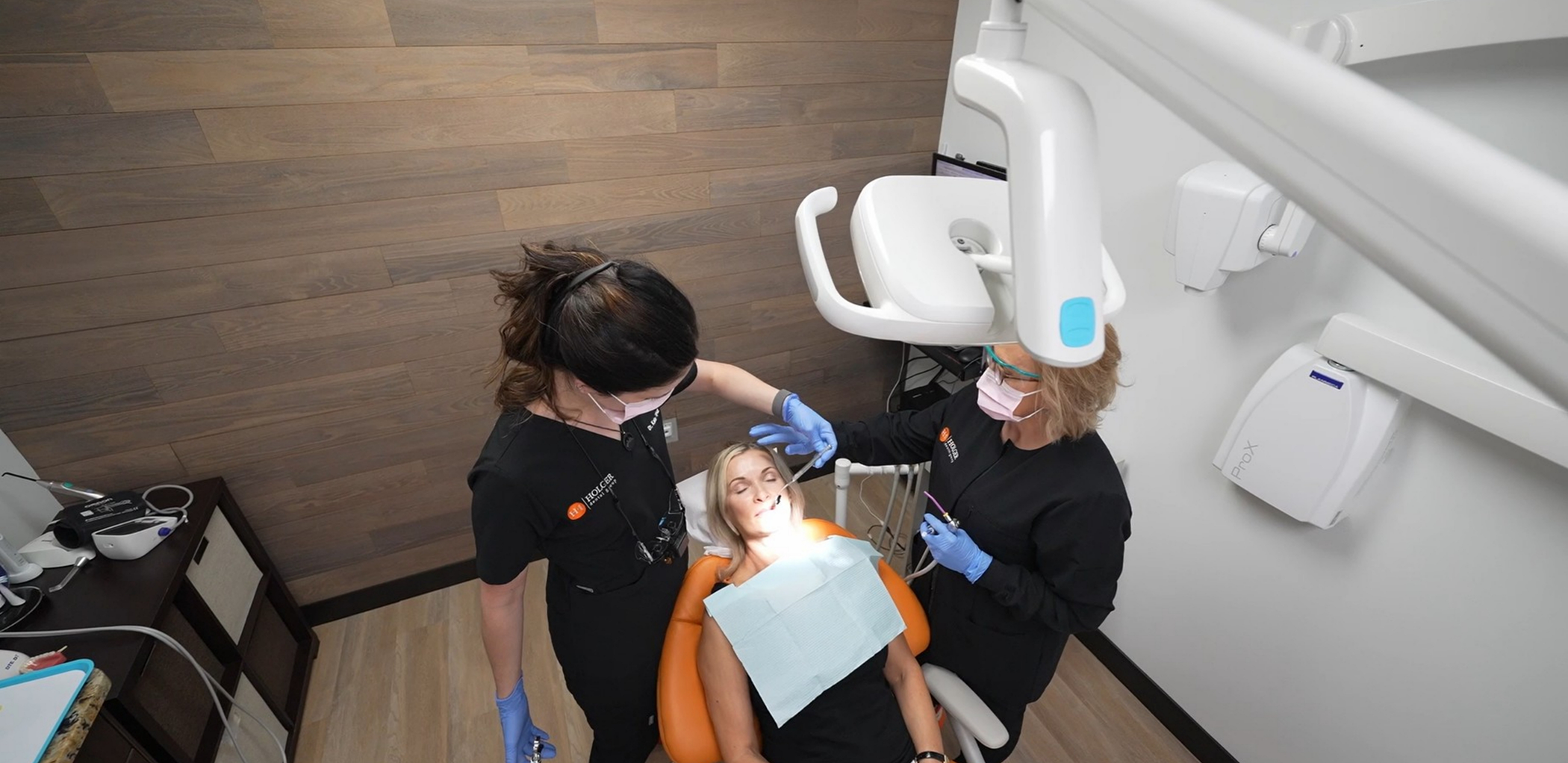 Dentist and assistant treating a patient