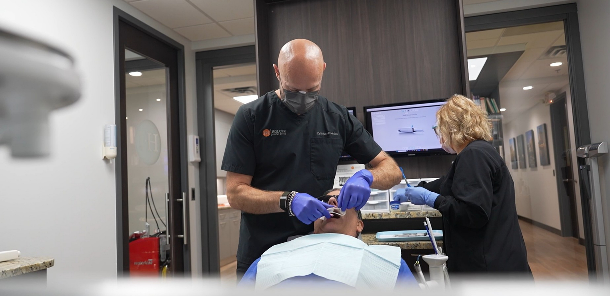 Doctor Holger and a dental assistant treating a patient