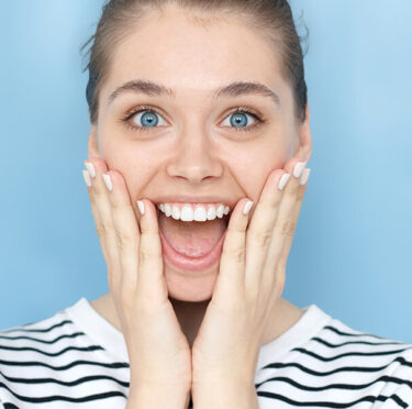 happy patient after dental bridge replacement